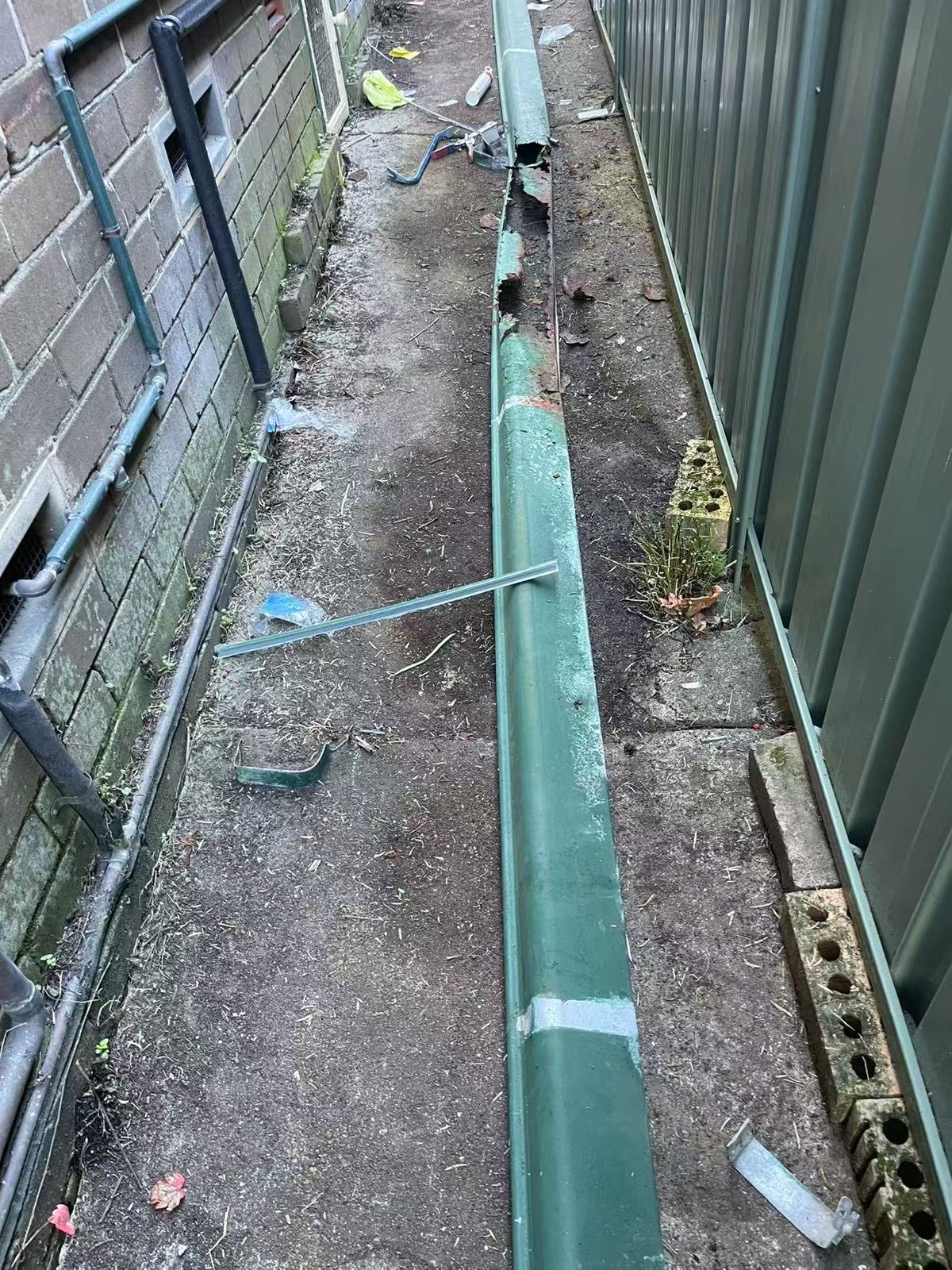Damaged gutter section removed for repair