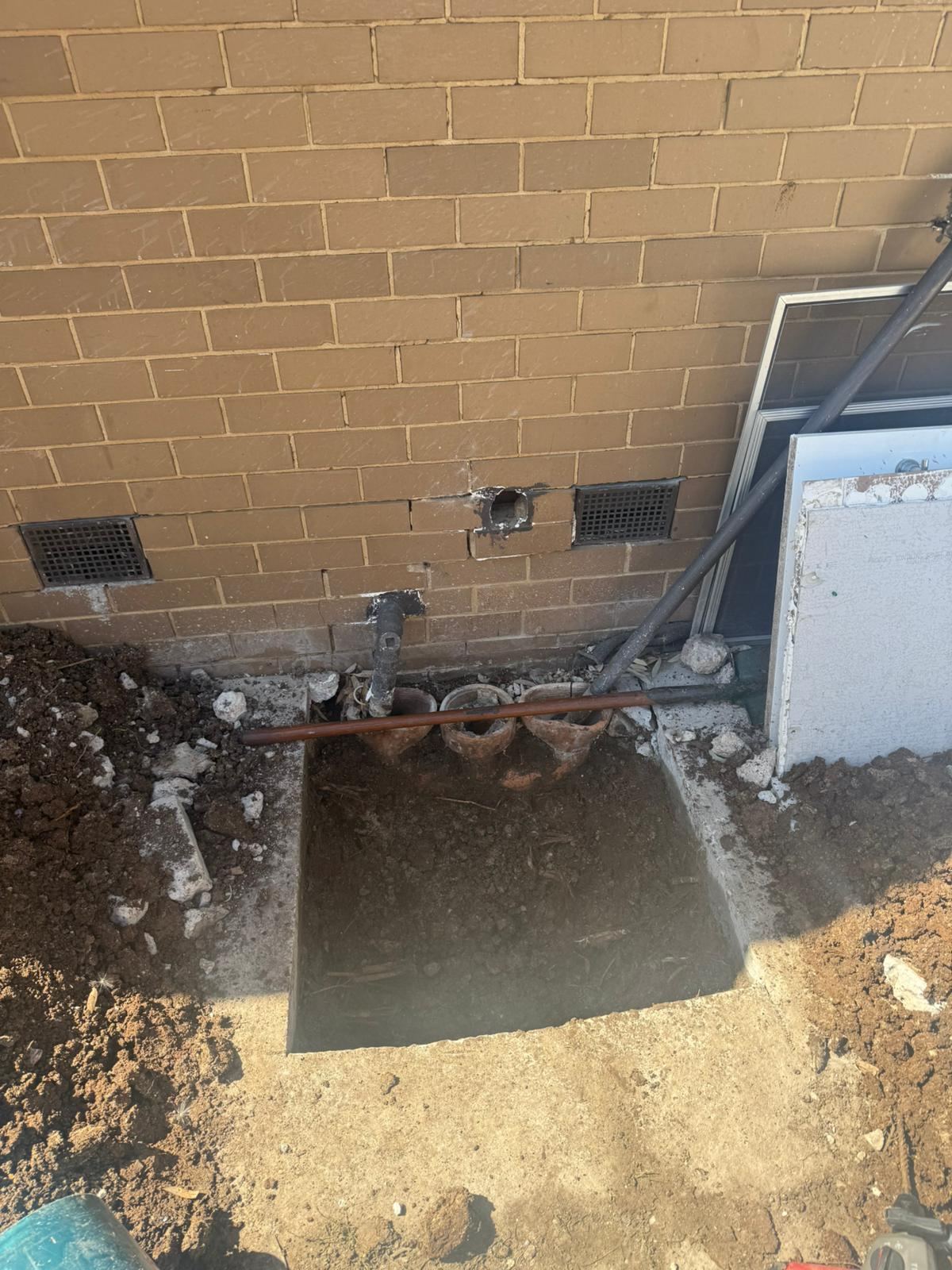 External drain connection repair beside a Melbourne brick home